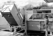Cart dumper on a stationary compactor